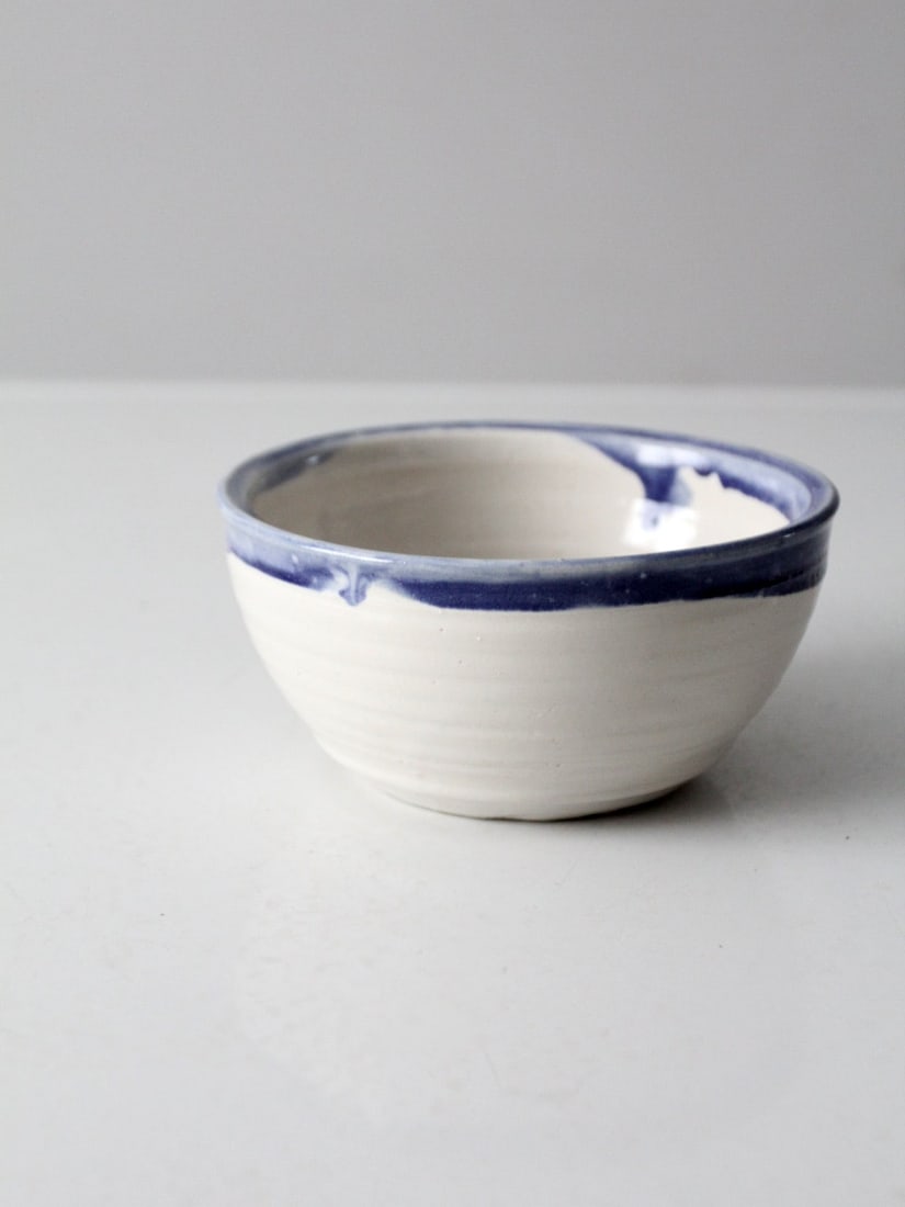 Signed Vintage Studio Pottery Bowl with Blue Drip Glaze 6.5 Inch: Signed Vintage Studio Pottery Bowl with Blue Drip Glaze 6.5 Inch This vintage studio pottery bowl showcases a unique handmade design, featuring a beautiful blue drip glaze lip. It is signed by the art