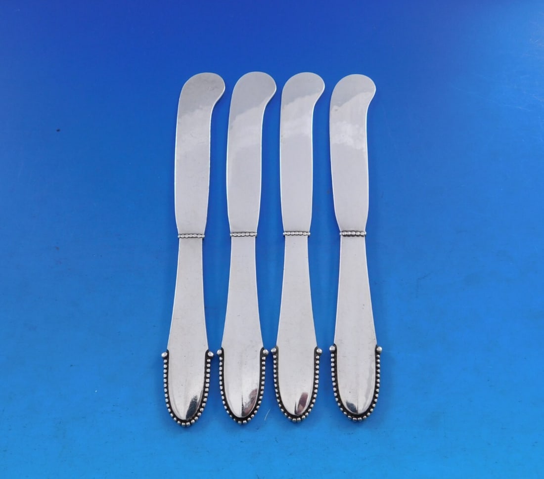 Georg Jensen Beaded Sterling Silver Butter Spreader Set of 4: Georg Jensen Beaded Sterling Silver Butter Spreader Set of 4 Enhance your dining experience with this exquisite set of 4 butter spreaders from Georg Jensen, crafted in the elegant Beaded pattern. Each