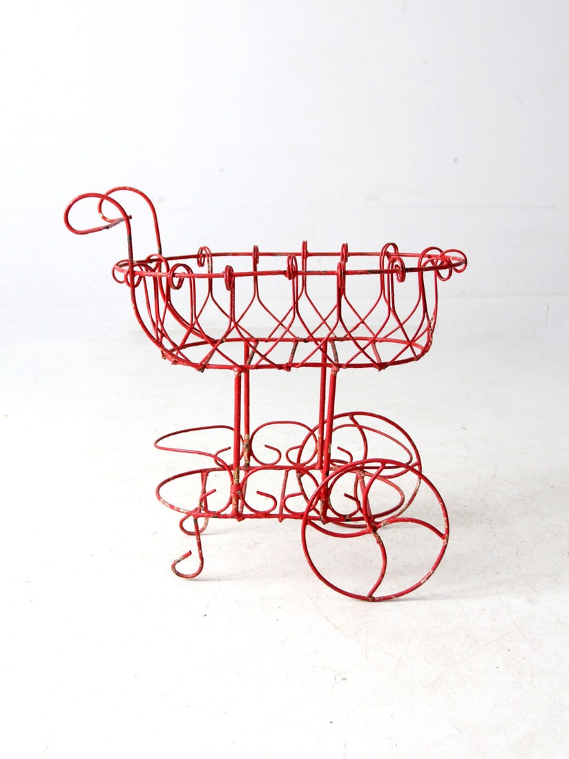 Vintage Red Metal Wire Planter Cart Two-Tier Garden Decor: Vintage Red Metal Wire Planter Cart Two-Tier Garden Decor This vintage red metal wire planter is designed to resemble a charming decorative cart, featuring intricate scrollwork and large wire wheels.