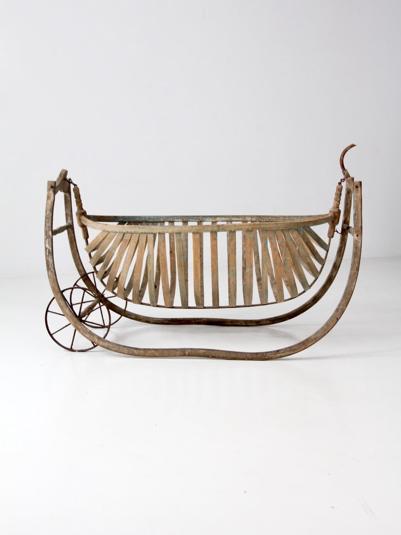 Mid-19th Century Antique Field Cradle with Metal Wheels: Mid-19th Century Antique Field Cradle with Metal Wheels This mid-19th century antique field cradle showcases a beautifully crafted wooden frame with a bentwood basket basin and metal wheels, making it