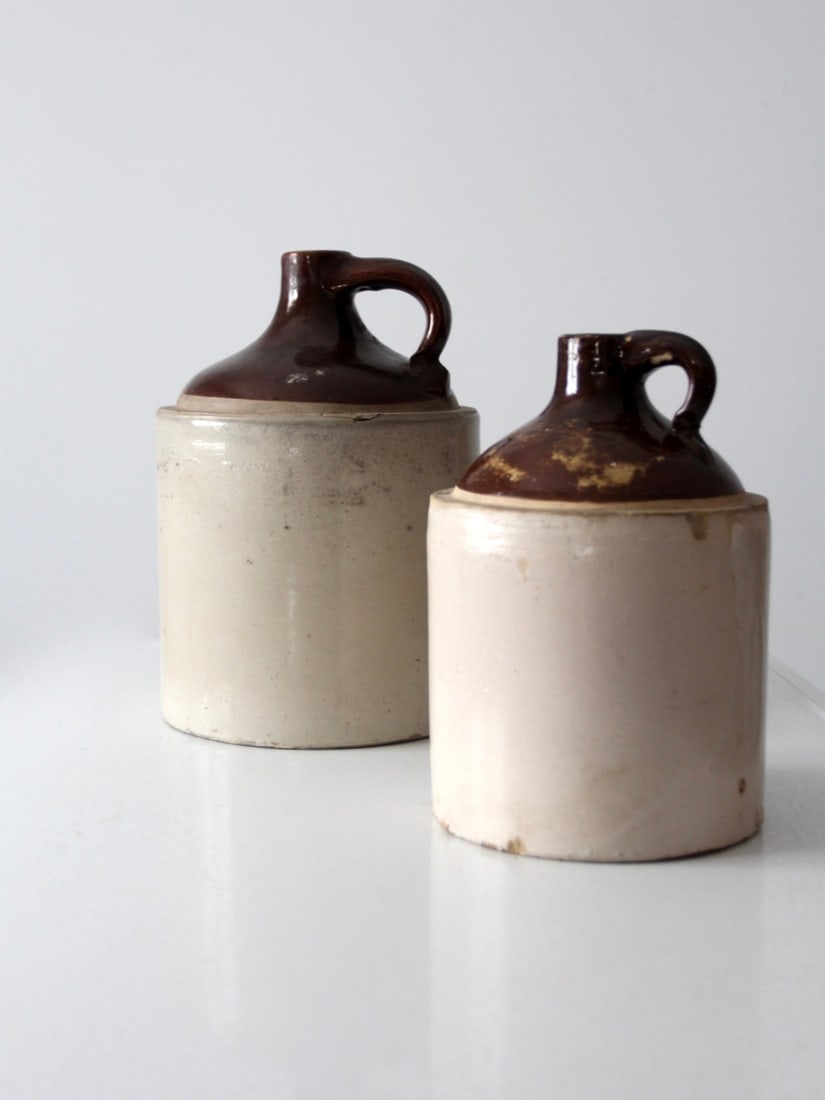 Antique Stoneware Jugs Set of 2 Saddle Brown Glaze: Antique Stoneware Jugs Set of 2 Saddle Brown Glaze This set of two antique stoneware jugs showcases the charm of traditional kitchen decor. Crafted from durable stoneware and finished with a saddle br
