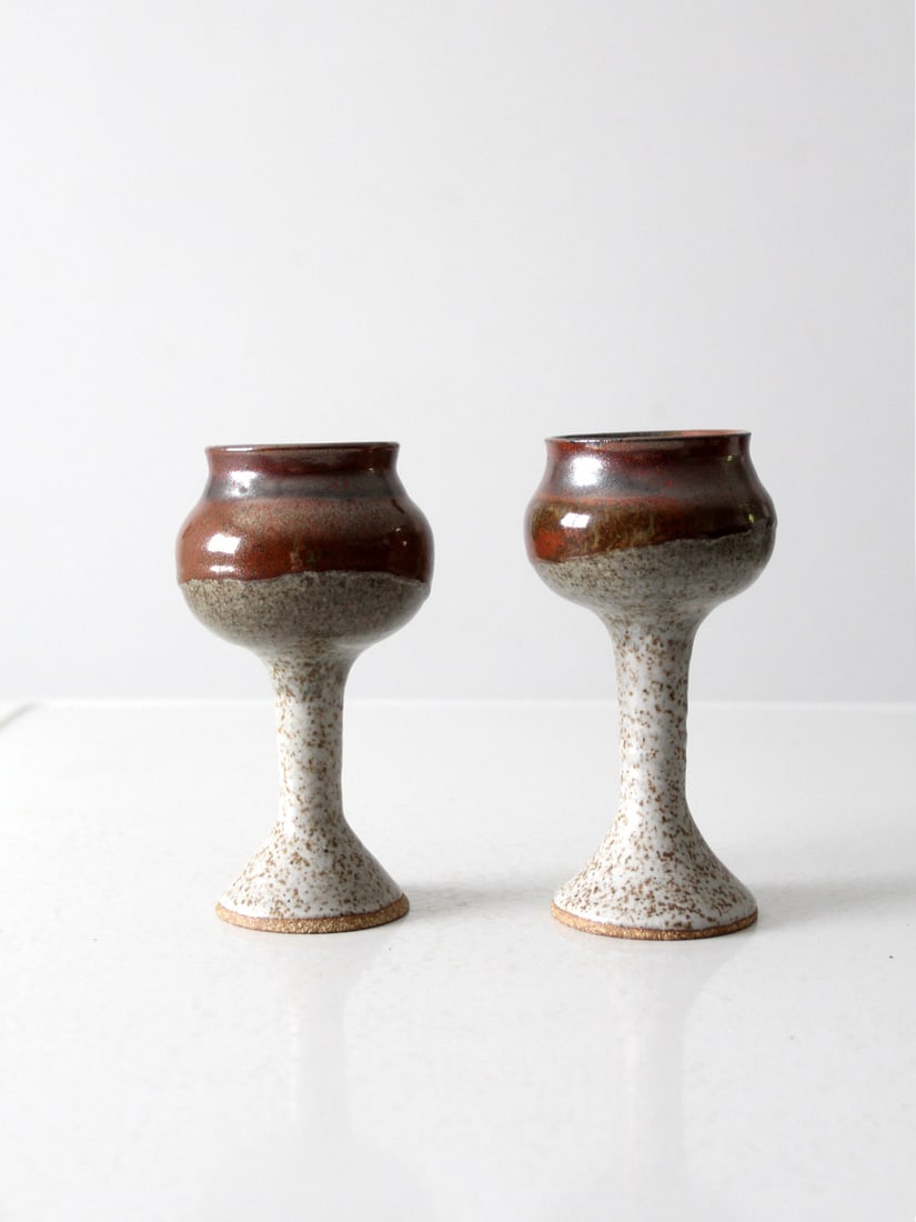 Handcrafted Vintage Studio Pottery Chalice Pair by Walden: Handcrafted Vintage Studio Pottery Chalice Pair by Walden This stunning pair of vintage studio pottery chalices embodies the artistry of handmade craftsmanship. Each chalice features a beautiful speck