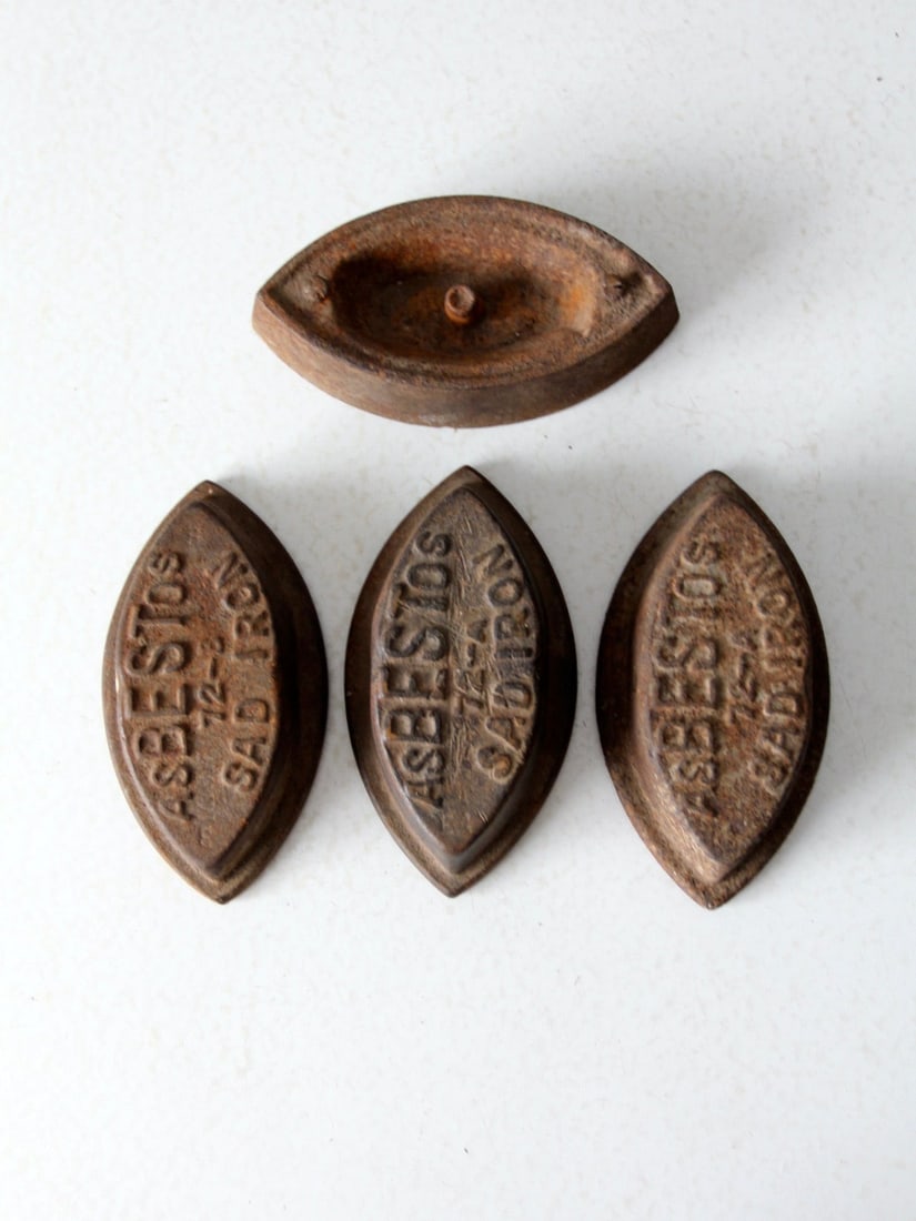Unique Antique Sad Iron Collection of 4 Asbestos Irons: Unique Antique Sad Iron Collection of 4 Asbestos Irons Discover a captivating collection of four antique sad irons from the late 19th century. This set includes three Asbestos brand irons alongside an