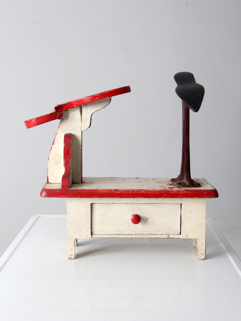 Rustic Vintage Cobbler Shoe Stand with Wooden Box and Iron Tool Storage: Rustic Vintage Cobbler Shoe Stand with Wooden Box and Iron Tool Storage This vintage cobbler's shoe stand station is a charming piece that showcases rustic craftsmanship. It features a painted wooden