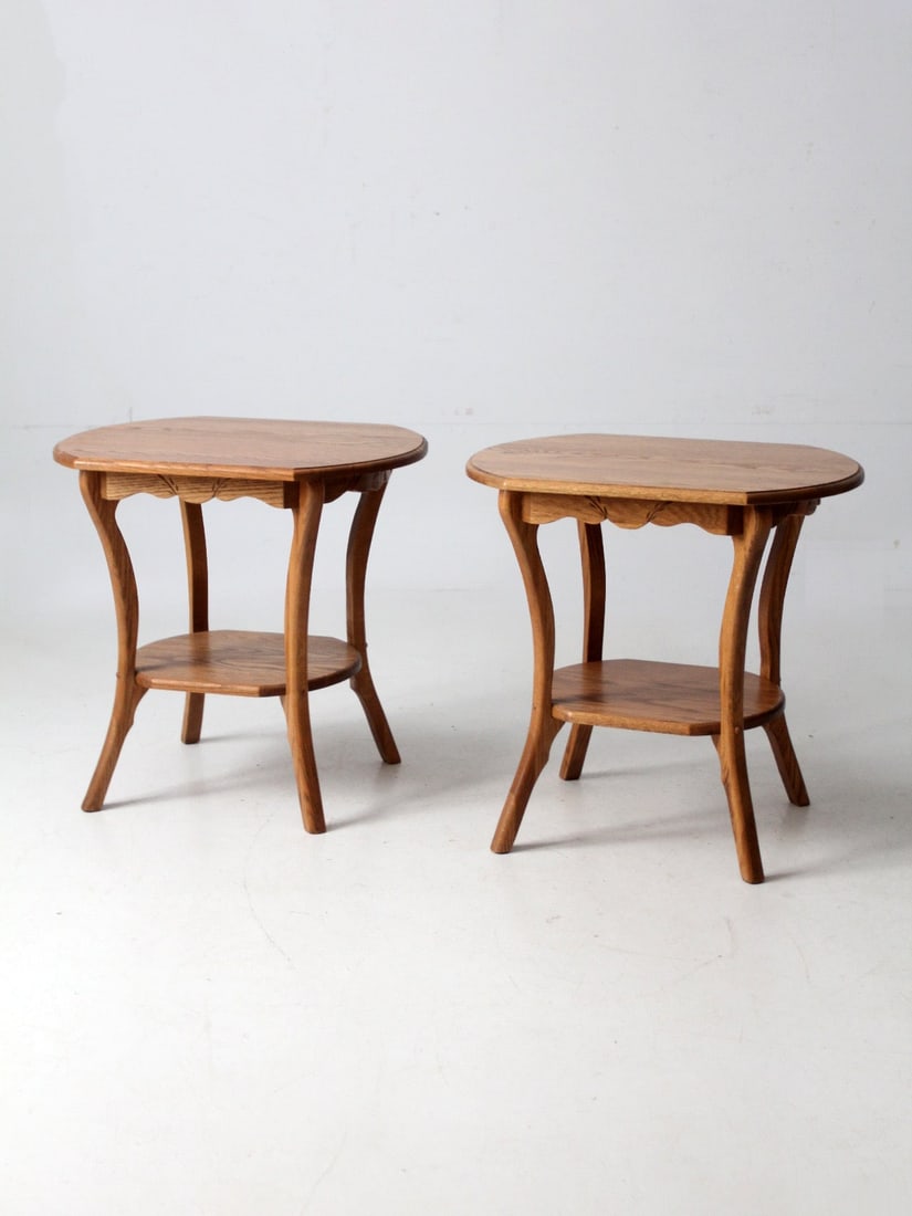 Set of Two Oak Side Tables in Colonial Revival Design: Set of Two Oak Side Tables in Colonial Revival Design This pair of vintage oak end tables features a Colonial Revival style with gently curved legs and a carved wheat sheaf apron. Each table is hand-f