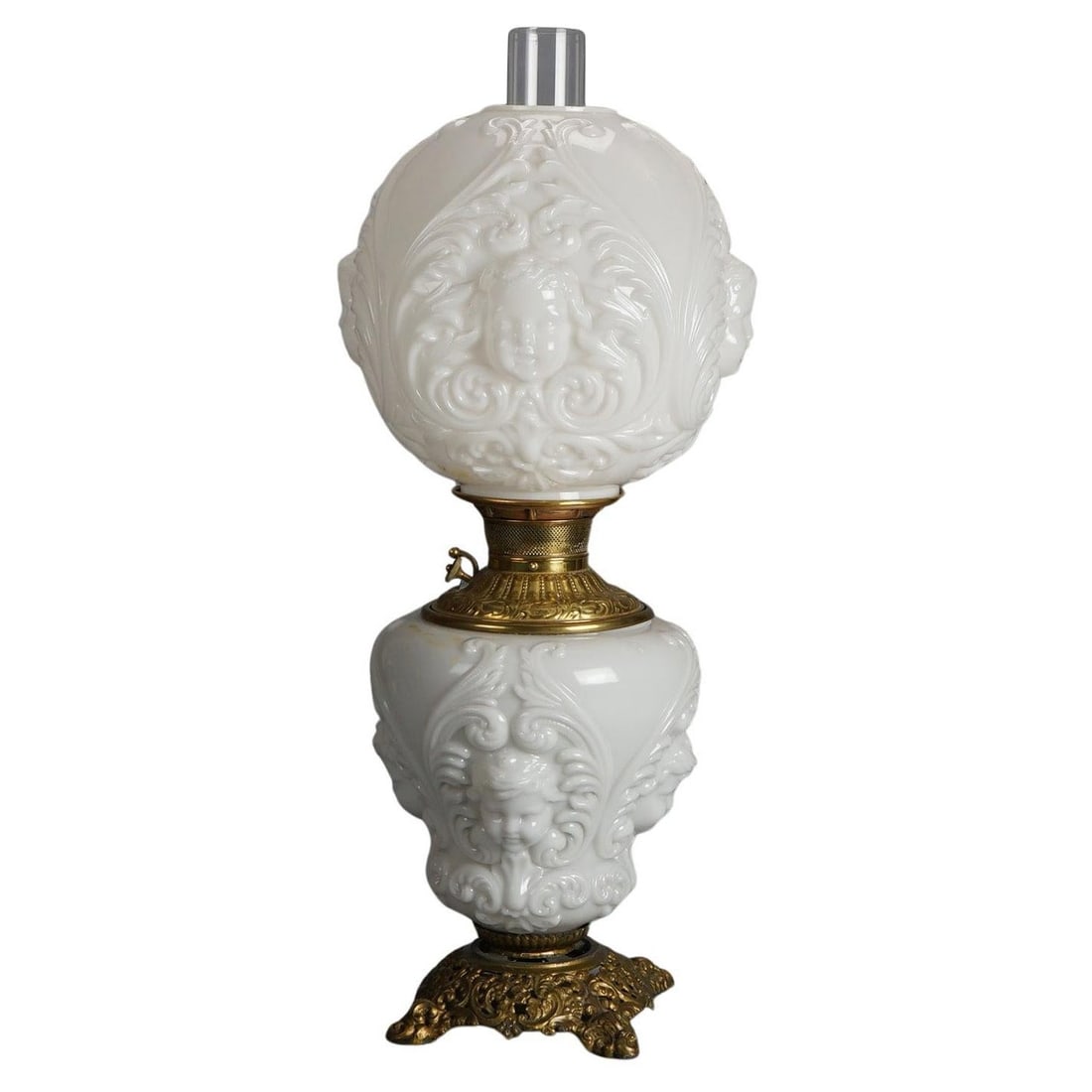 Early 1900s Blanc De Chine Cupid Lamp Brass Bronze Base Blown Glass Shade: Early 1900s Blanc De Chine Cupid Lamp Brass Bronze Base Blown Glass Shade This antique oil lamp from circa 1900 features a Blanc De Chine design with intricate brass and bronze detailing. The lamp is