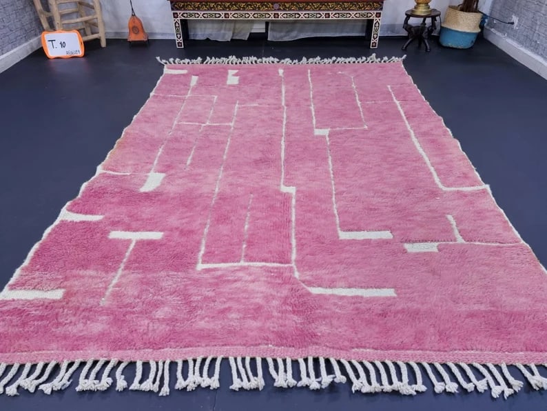 Elegant Soft Pink Handmade Wool Rug 9 x 5 Feet from Morocco: Elegant Soft Pink Handmade Wool Rug 9 x 5 Feet from Morocco Discover the beauty of this Elegant Soft Pink Handmade Engraved Wool Rug, expertly handwoven in the Atlas Mountains by skilled local Berber