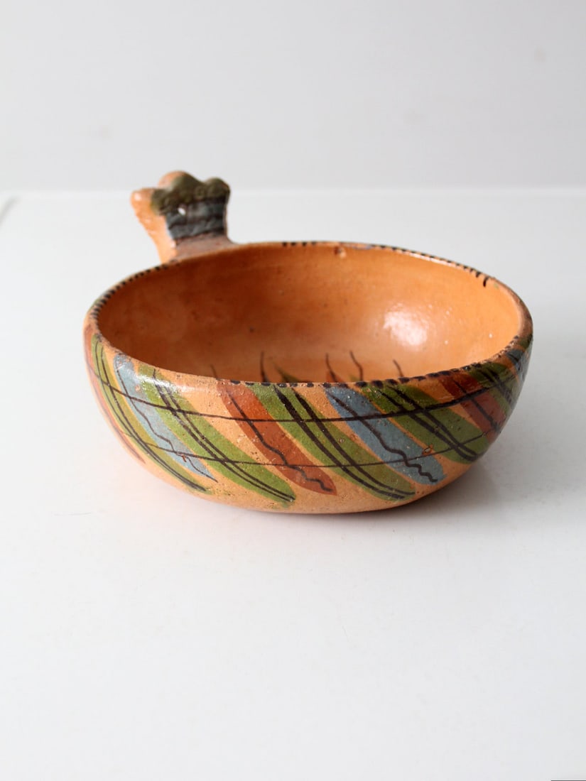 Hand-Painted Vintage Mexican Red Clay Pottery Bowl with Handle: Hand-Painted Vintage Mexican Red Clay Pottery Bowl with Handle This vintage Mexican redware pottery bowl features a hand-painted striped design that reflects traditional folk art techniques, enhancing
