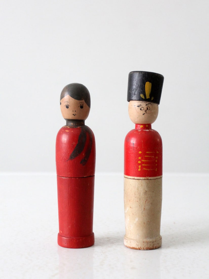 Mid-Century Figural Wood Box Set Soldier and Woman: Mid-Century Figural Wood Box Set Soldier and Woman This charming pair of mid-20th century figural boxes features a soldier and a woman in a striking red dress. Each tall and slender box opens in half,