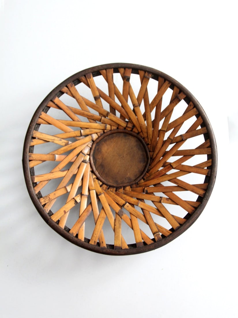 Vintage Woven Rattan Bowl with Dark Wood Frame 16.25 in: Vintage Woven Rattan Bowl with Dark Wood Frame 16.25 in Discover the charm of this vintage woven rattan basket, perfect as a decorative bowl or centerpiece. It features a dark wood frame and base, com