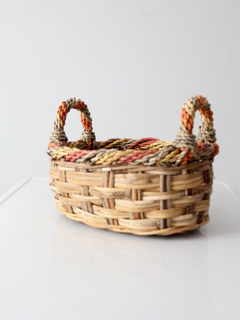 Colorful Vintage Braided Wicker Basket for Home Decor: Colorful Vintage Braided Wicker Basket for Home Decor Enhance your home decor with this vintage braided wicker basket, featuring vibrant red, green, and goldenrod woven details that elegantly frame th