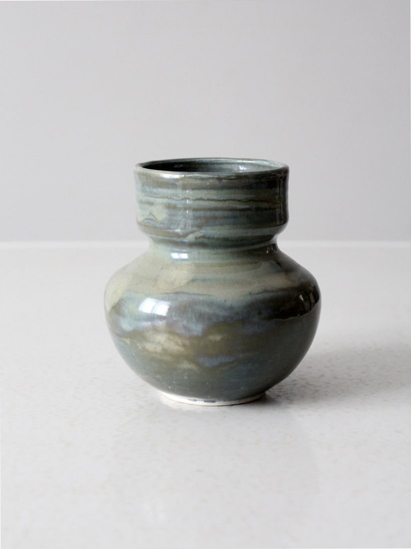Handmade Vintage Studio Pottery Vase in Soft Glazes: Handmade Vintage Studio Pottery Vase in Soft Glazes This vintage handmade studio pottery vase showcases a beautifully balanced, rounded form adorned with a flowing glaze in soft shades of gray, blue,