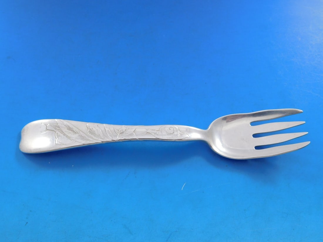 Tiffany Sterling Silver Lap Over Acid Etched Fish Fork with Snails 6.5": Tiffany Sterling Silver Lap Over Acid Etched Fish Fork with Snails 6.5" Experience the elegance of this Tiffany & Co. sterling silver fish fork, beautifully designed in the Lap Over Edge pattern. Feat