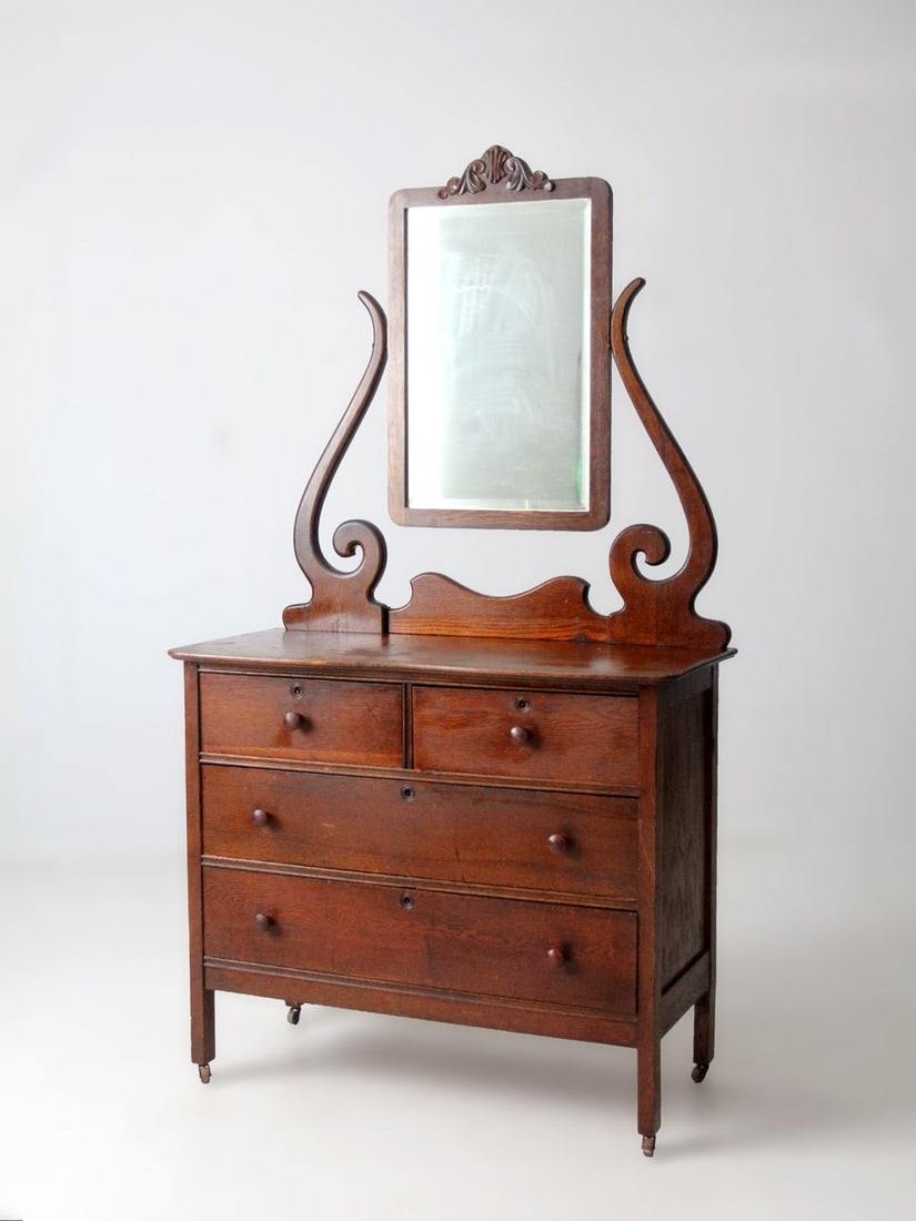 Victorian Era Wooden Dresser Featuring Tall Beveled Mirror: Victorian Era Wooden Dresser Featuring Tall Beveled Mirror This antique Victorian dresser features a refined silhouette and a tall beveled glass mirror, embodying the transitional design between the l