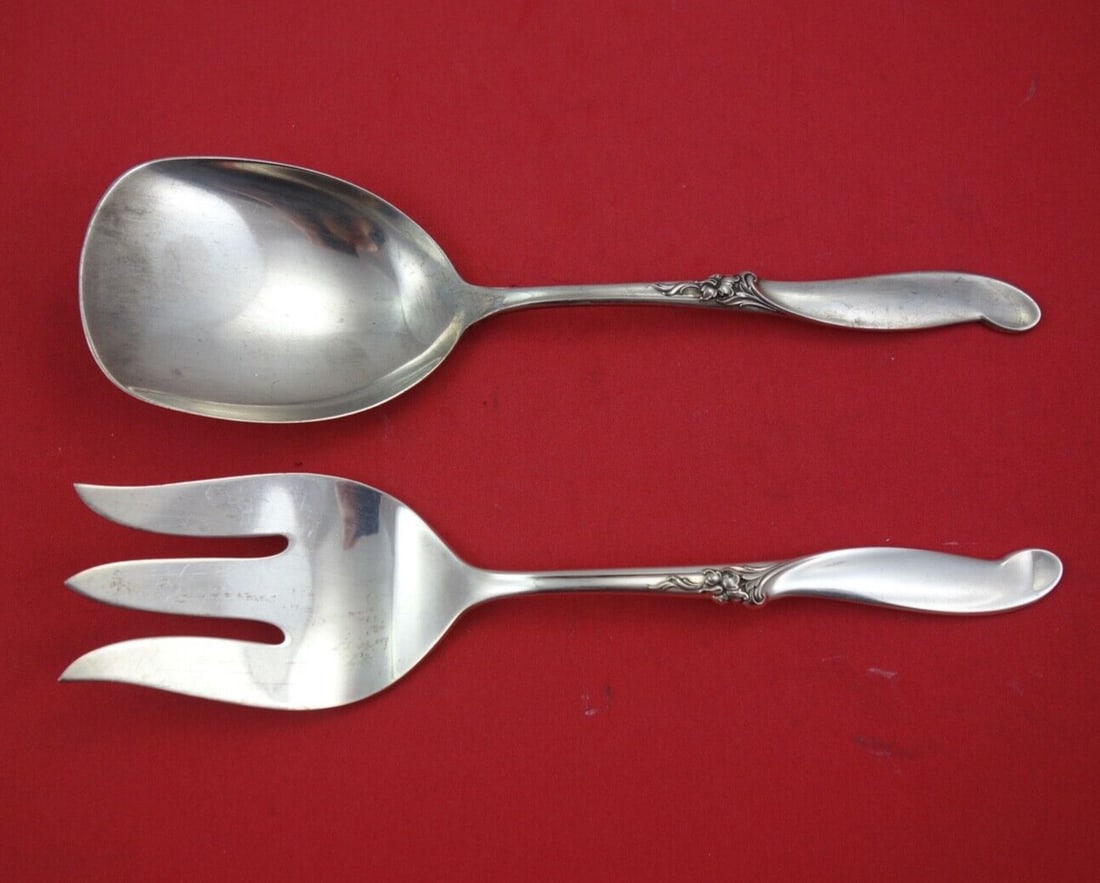 International Sterling Silver Melody Salad Serving Set 9": International Sterling Silver Melody Salad Serving Set 9" Enhance your dining experience with this exquisite Silver Melody Salad Serving Set by International Sterling. Crafted from high-quality sterli