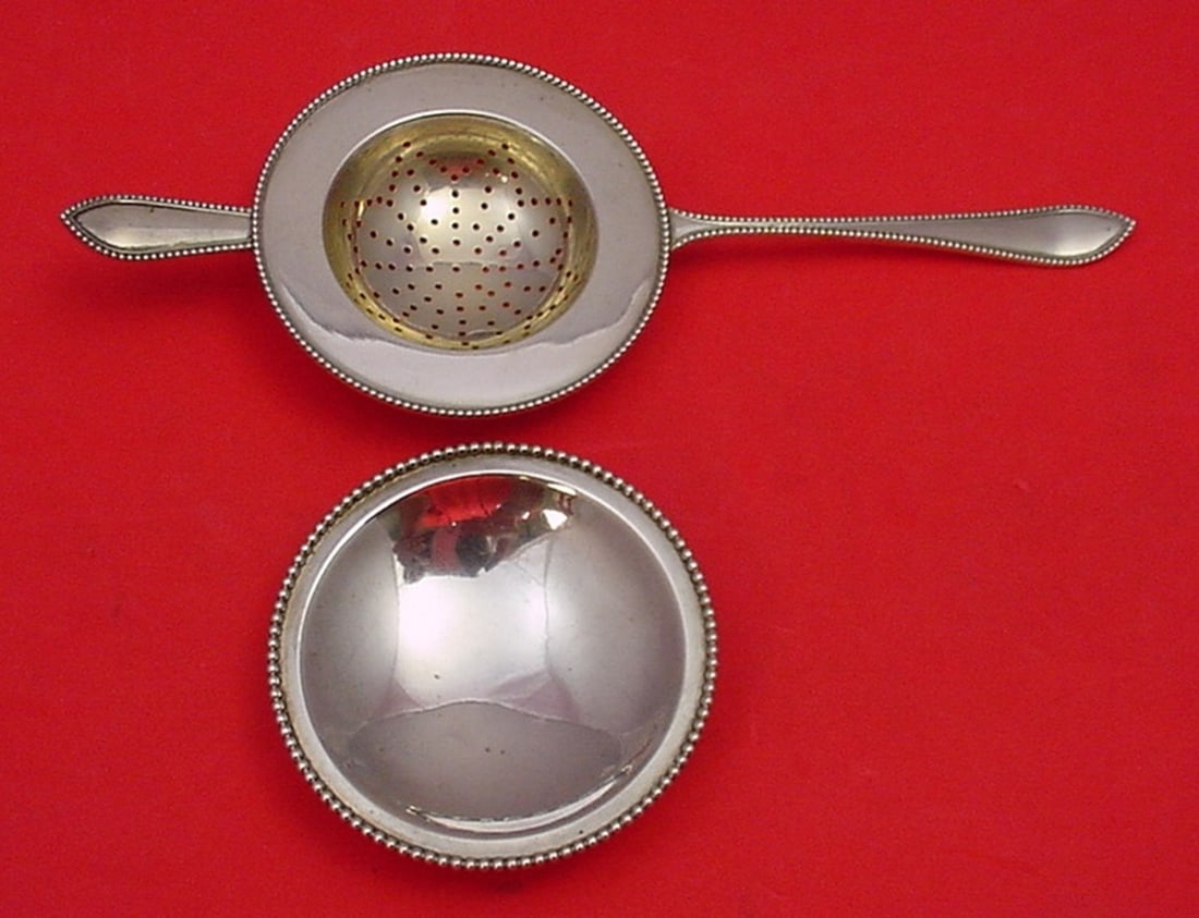 Magnus Aase Perle .830 Silver Tea Strainer & Underplate Set 2pc: Magnus Aase Perle .830 Silver Tea Strainer & Underplate Set 2pc This exquisite tea strainer and underplate set from the Perle collection by Magnus Aase showcases elegant Norwegian craftsmanship. Made