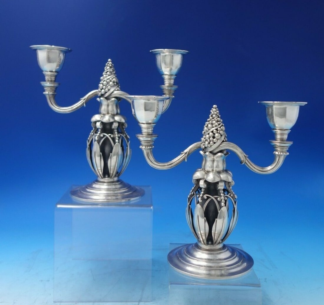 Georg Jensen Sterling Silver Candelabra Pair 2-Light Fir Cones #244: Georg Jensen Sterling Silver Candelabra Pair 2-Light Fir Cones #244 This exquisite pair of Georg Jensen candelabras epitomizes elegance and craftsmanship. Each candelabra features a stunning two-light