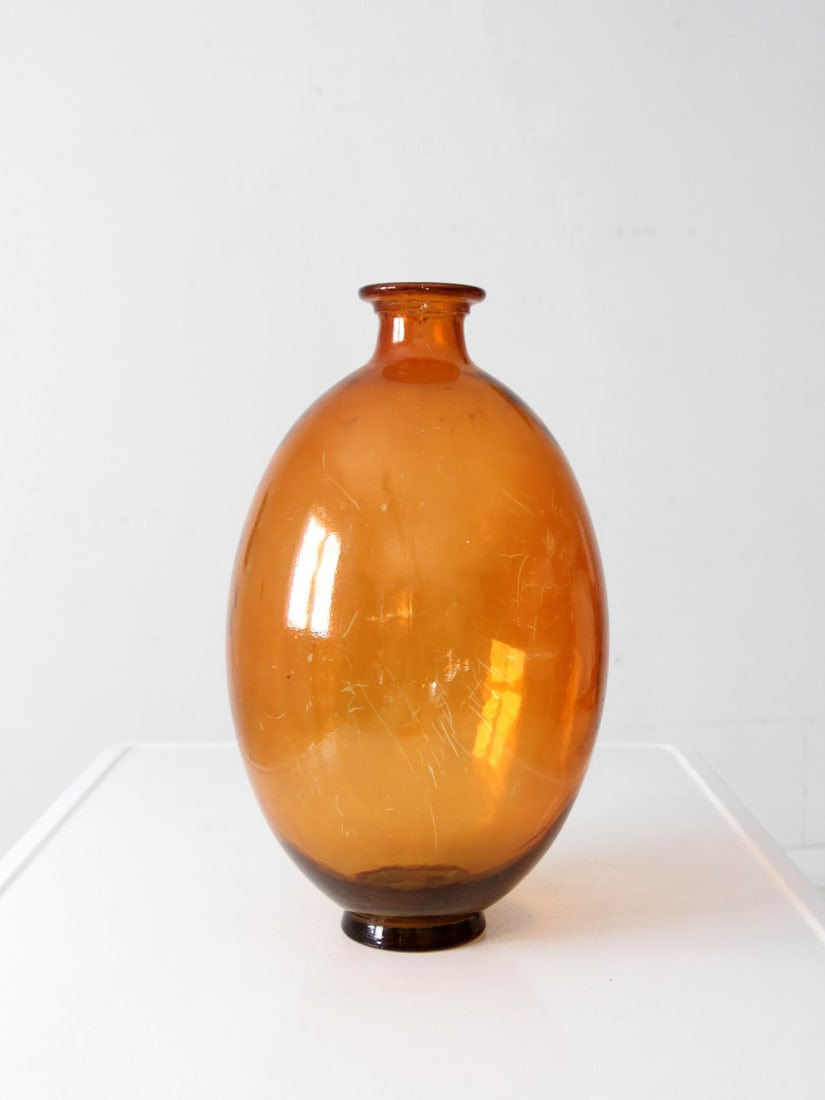 Mid-Century Spanish Amber Glass Vase 17 Inches: Mid-Century Spanish Amber Glass Vase 17 Inches This exquisite mid-century Spanish glass vase features a rich amber hue, marked "Made in Spain" on the base. Its elegant rounded form and narrow opening