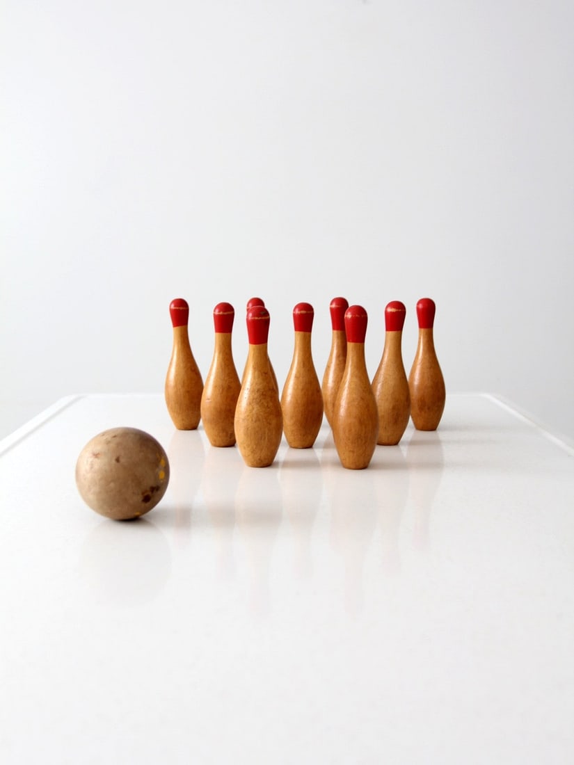 Vintage Early 20th Century Tabletop Bowling Game with 9 Wooden Skittles: Vintage Early 20th Century Tabletop Bowling Game with 9 Wooden Skittles Discover an early 20th-century tabletop bowling game set, perfect for vintage enthusiasts and collectors. This charming set incl