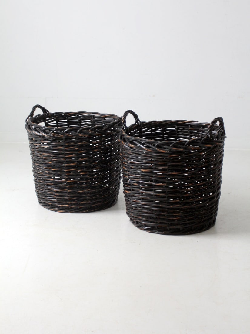 Vintage Black Woven Cane Baskets Pair with Braided Handles: Vintage Black Woven Cane Baskets Pair with Braided Handles This pair of vintage woven cane baskets is a stunning addition to any home decor. Each large black basket features robust braided double hand