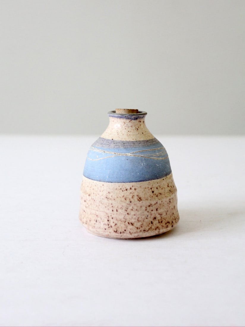 Signed Vintage Studio Pottery Jar with Blue Stripe Accent: Signed Vintage Studio Pottery Jar with Blue Stripe Accent This vintage studio pottery jar showcases exceptional craftsmanship with a handmade, wheel-turned design. It features a speckled tan glaze com
