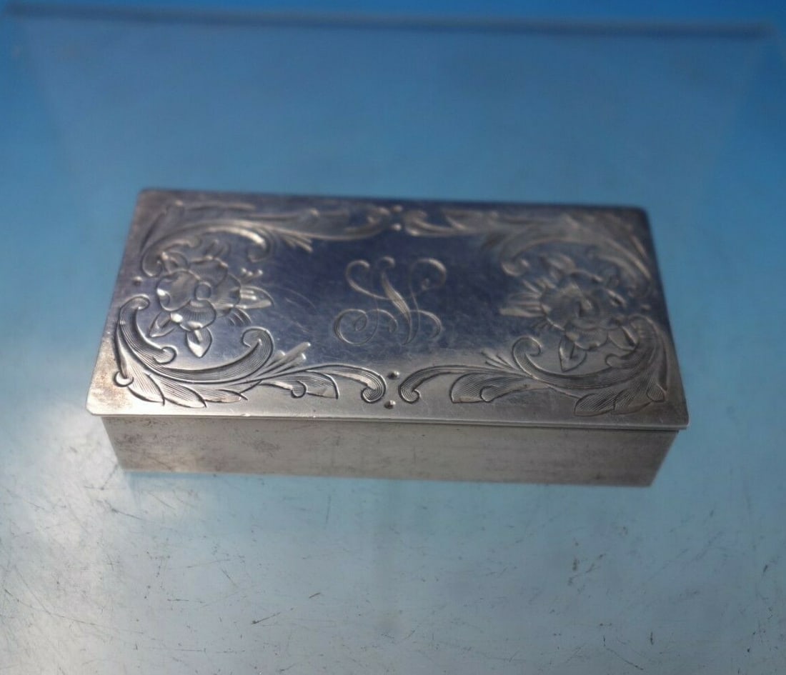 Lutz Handmade Sterling Silver Stamp Box with Bright-Cut Flowers 1910: Lutz Handmade Sterling Silver Stamp Box with Bright-Cut Flowers 1910 This exquisite Lutz handmade sterling silver stamp box, crafted around 1910, features a charming design of bright-cut flowers. With