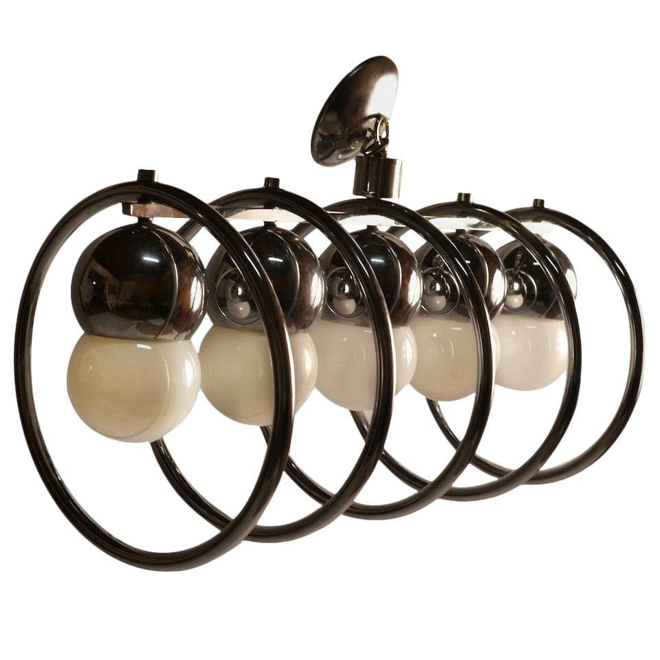 Modern Chrome Five Light Chandelier Circular Fixture: Modern Chrome Five Light Chandelier Circular Fixture Illuminate your space with this stunning Chrome Five Light Ring Fixture. Featuring a modern design, this chandelier showcases circular chrome rings