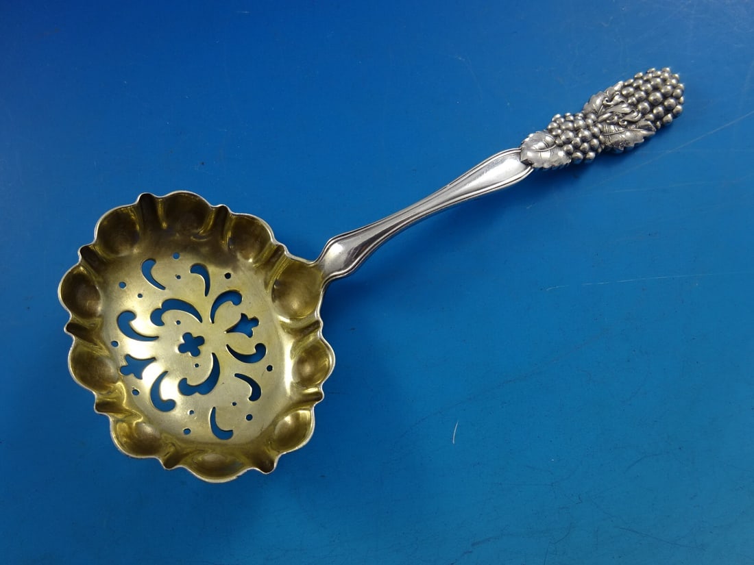 Tiffany & Co Blackberry Sterling Silver Sugar Sifter Gold Washed 5 3/4": Tiffany & Co Blackberry Sterling Silver Sugar Sifter Gold Washed 5 3/4" This exquisite sugar sifter from Tiffany & Co. features the elegant Blackberry pattern, showcasing a beautifully designed 5 3/4"