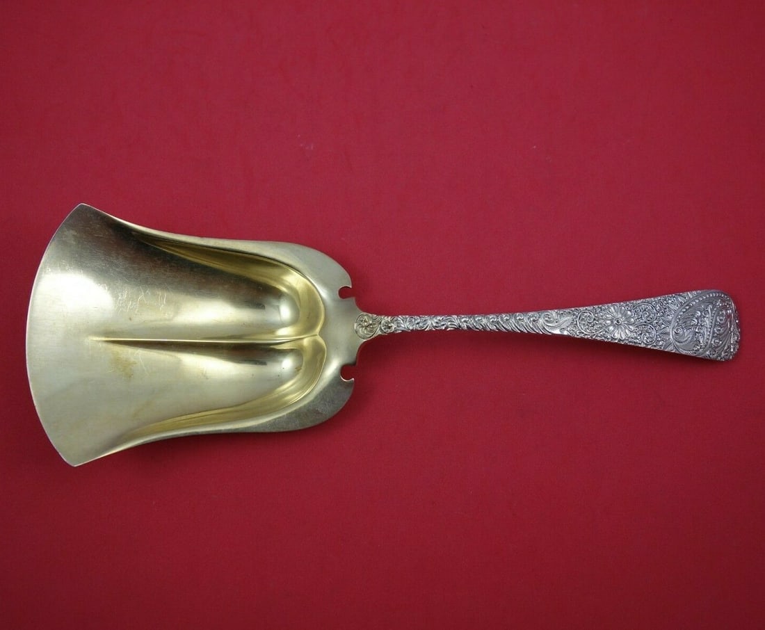 J.E. Caldwell Antique Engraved Sterling Silver Cracker Scoop 10 1/2" Gold Wash 1888: J.E. Caldwell Antique Engraved Sterling Silver Cracker Scoop 10 1/2" Gold Wash 1888 This exquisite cracker scoop, crafted by J.E. Caldwell, features the elegant Antique Engraved pattern, showcasing th