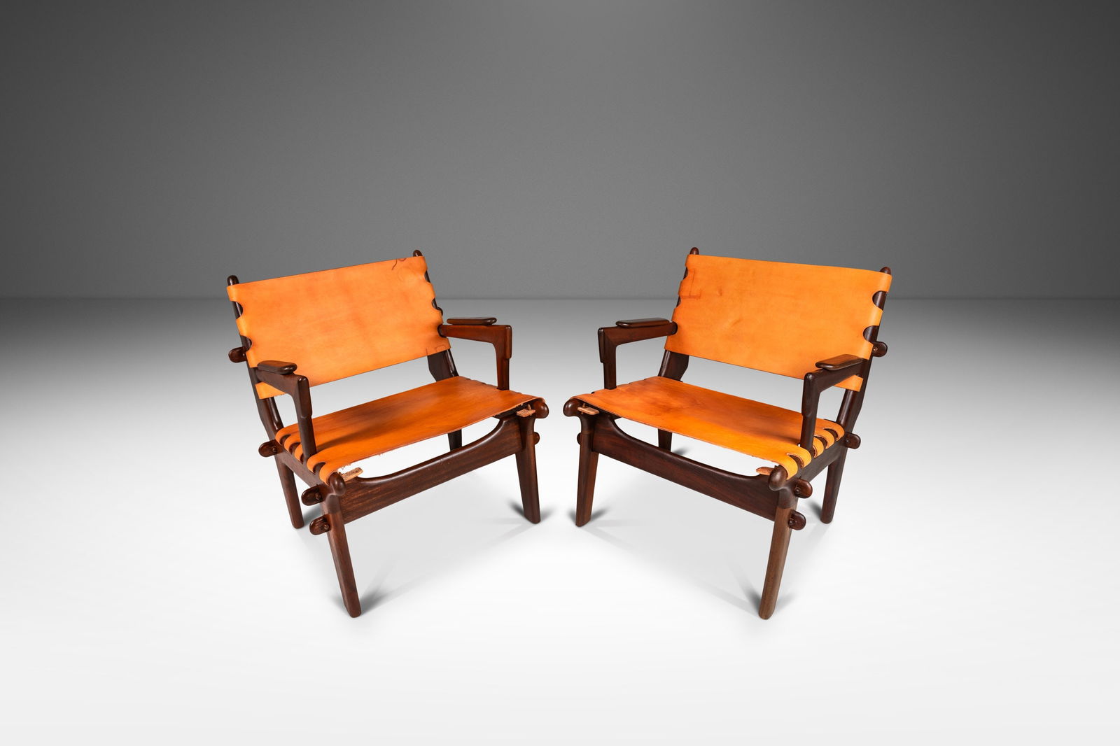 Mid-Century Modern Sling Chairs by Angel Pazmino Set of Two: Mid-Century Modern Sling Chairs by Angel Pazmino Set of Two Discover a remarkable set of two Mid-Century Modern sling chairs designed by the esteemed Angel Pazmino from Ecuador, dating back to the 196