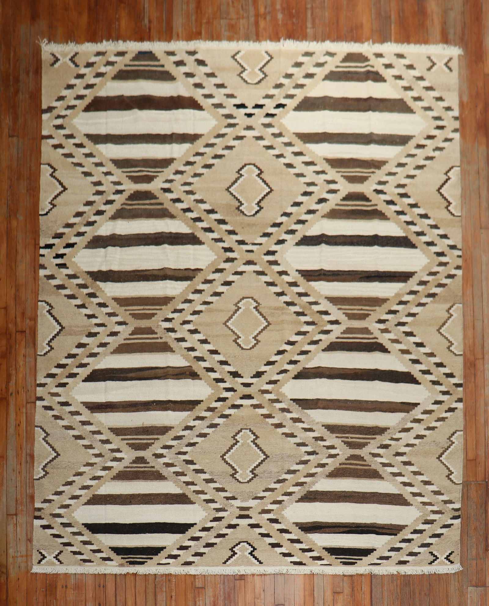 8'3" x 10'7" Hand-Knotted Wool Turkish Geometric Kilim Rug: 8'3" x 10'7" Hand-Knotted Wool Turkish Geometric Kilim Rug This mid-century modern room size Turkish kilim features a hand-knotted wool construction with striking geometric patterns in brown, ivory, a
