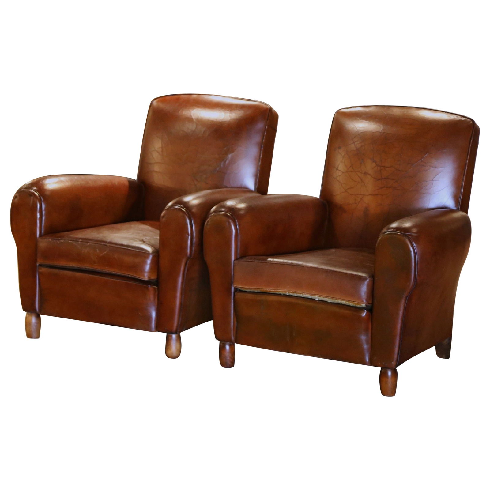 Set of 2 Early 20th Century French Art Deco Club Armchairs in Patinated Leather: Set of 2 Early 20th Century French Art Deco Club Armchairs in Patinated Leather This pair of early 20th-century French club armchairs showcases classic Art Deco design, crafted around 1920. Upholstere