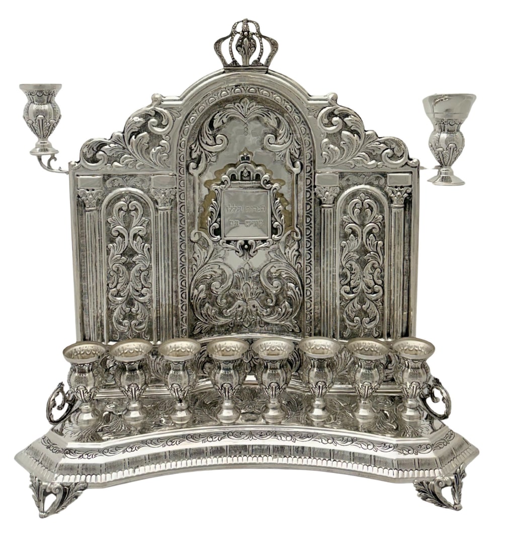 Handmade 925 Sterling Silver Crown Menorah with Swirl Leaf Design: Handmade 925 Sterling Silver Crown Menorah with Swirl Leaf Design This exquisite 925 sterling silver Menorah is a stunning piece for Chanukah celebrations. It showcases a handmade chased swirl leaf de