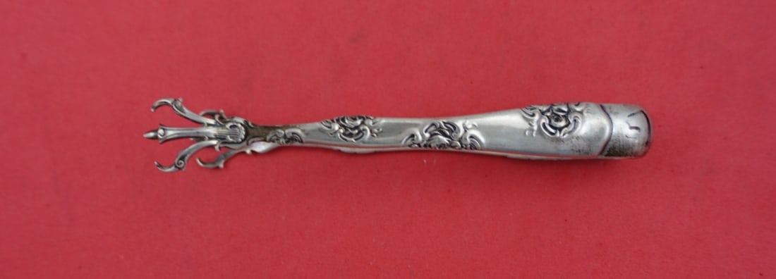 Whiting Rose and Scroll Sterling Silver Sugar Tong 4": Whiting Rose and Scroll Sterling Silver Sugar Tong 4" This exquisite sugar tong from the Rose and Scroll pattern by Whiting is a stunning example of sterling silver craftsmanship. Measuring 4 inches i