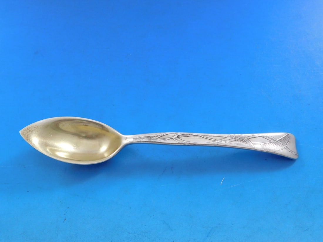 Tiffany Sterling Silver Lap Over Edge Grapefruit Spoon Buffalo Grass 6": Tiffany Sterling Silver Lap Over Edge Grapefruit Spoon Buffalo Grass 6" This exquisite grapefruit spoon features the elegant Lap Over Edge pattern by Tiffany & Co., crafted from high-quality sterling