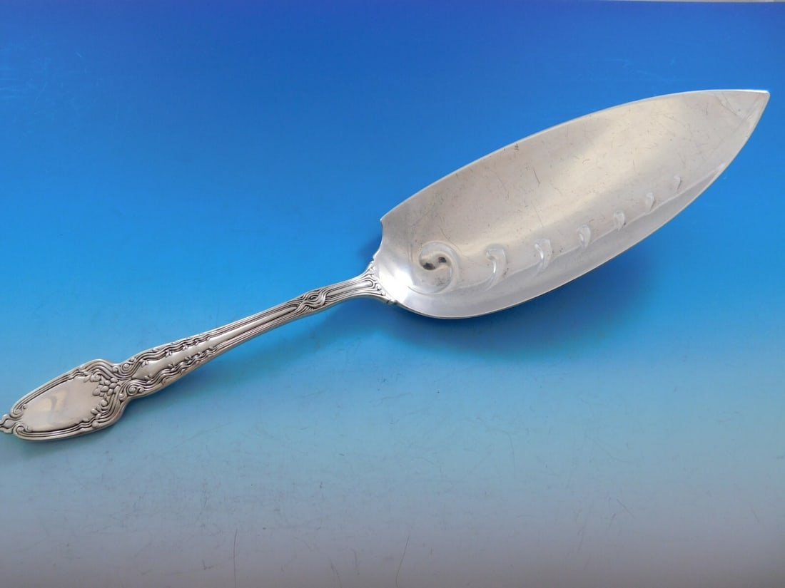 Tiffany & Co. Broom Corn Sterling Silver Fish Server 12 1/4": Tiffany & Co. Broom Corn Sterling Silver Fish Server 12 1/4" This exquisite fish server from Tiffany & Co. features a stunning embossed blade and is crafted from high-quality sterling silver. With a l