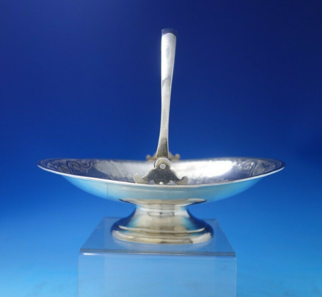 Antique Russian 84 .875 Silver Basket with Bright-Cut Village Scenes: Antique Russian 84 .875 Silver Basket with Bright-Cut Village Scenes This exquisite Russian basket, crafted from .875 silver, features stunning bright-cut scenes depicting a village by a river. The pi