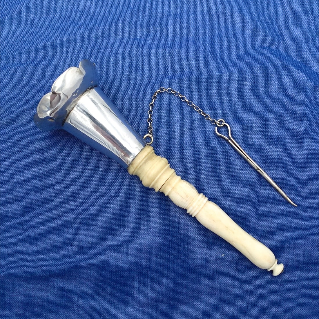 Victorian Sterling Silver Tussie Mussie with Scalloped Rim and Chain 4 3/4": Victorian Sterling Silver Tussie Mussie with Scalloped Rim and Chain 4 3/4" This exquisite Sterling Silver Tussie Mussie features a beautifully scalloped rim and comes complete with its original pin a