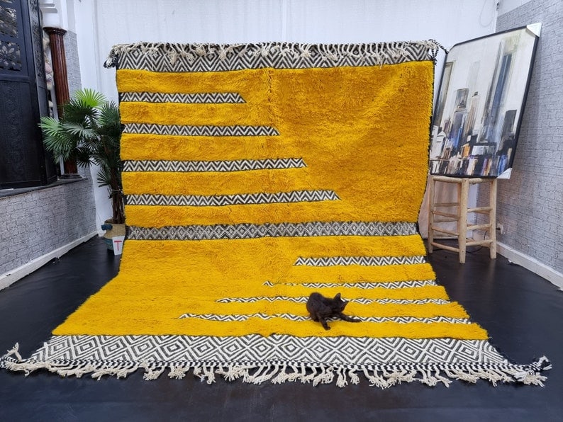 Authentic Moroccan Berber Yellow Wool Rug 9.84 x 6.56 Feet: Authentic Moroccan Berber Yellow Wool Rug 9.84 x 6.56 Feet Transform your space with this Elegant Authentic Soft Engraved Yellow Handmade Moroccan Berber Wool Rug. Handwoven in the picturesque Atlas M