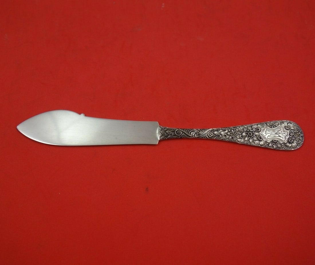 Whiting Antique Chased Sterling Silver Master Butter Knife 7 1/4" with Shield: Whiting Antique Chased Sterling Silver Master Butter Knife 7 1/4" with Shield This exquisite master butter knife, crafted by Whiting, showcases the Antique Chased pattern, a hallmark of fine craftsman