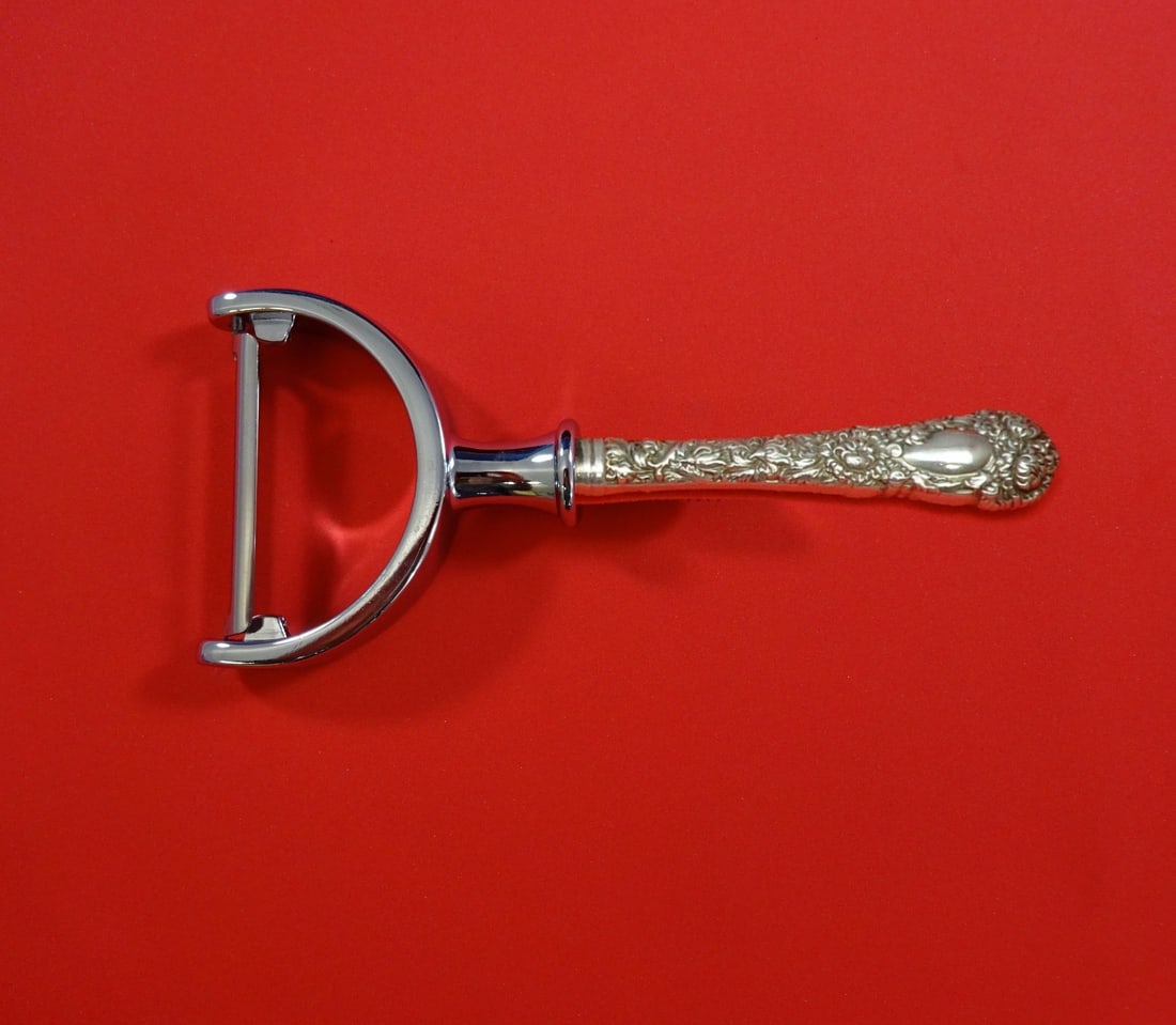 Durgin Chrysanthemum Sterling Silver Custom Vegetable Peeler 6": Durgin Chrysanthemum Sterling Silver Custom Vegetable Peeler 6" This exquisite vegetable peeler features the elegant Chrysanthemum pattern by Durgin. Crafted from sterling silver, it boasts a hollow h