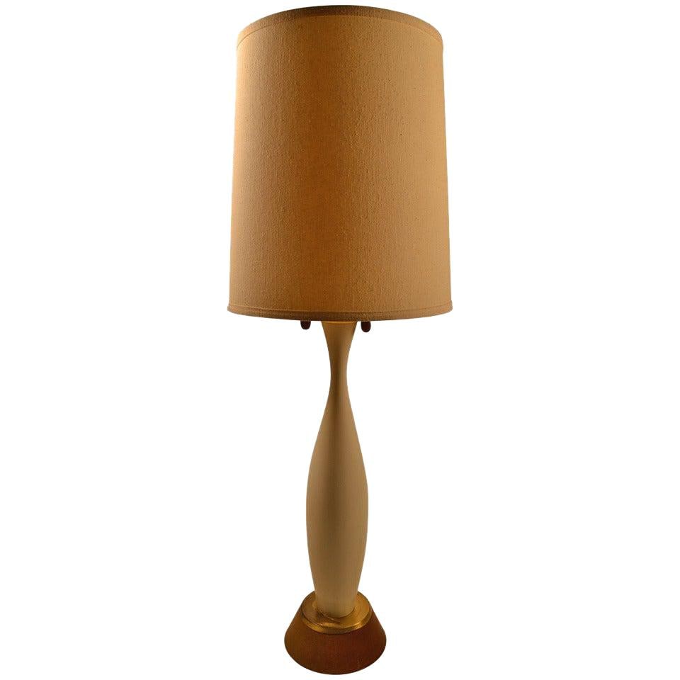 Elegant Mid Century White Wood Table Lamp 41 Inches: Elegant Mid Century White Wood Table Lamp 41 Inches This Mid Century Table Lamp showcases a graceful design, featuring a white painted wood finish that complements a variety of decor styles. It is in