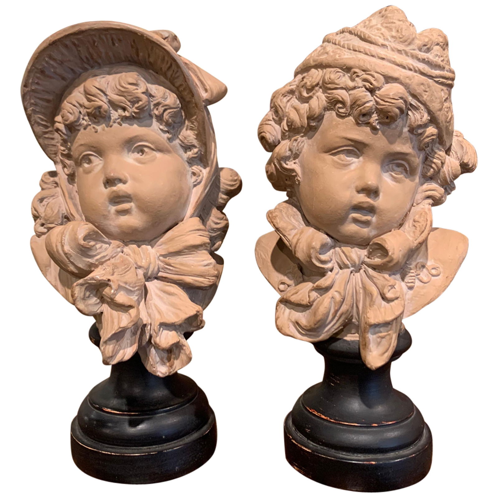 Set of 2 19th Century French Terracotta Busts by Emile Guillemin: Set of 2 19th Century French Terracotta Busts by Emile Guillemin This delightful pair of 19th-century French terracotta busts of children, crafted by Emile Guillemin around 1880, adds a cheerful touch