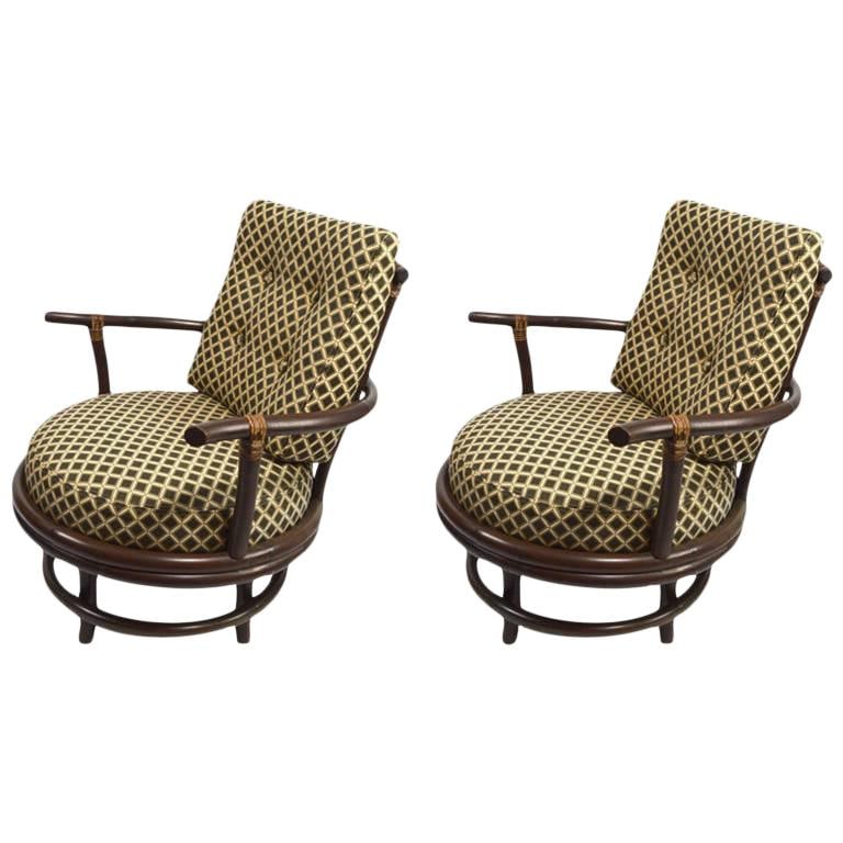 Distinctive Pair of Chocolate Bamboo Swivel Lounge Chairs: Distinctive Pair of Chocolate Bamboo Swivel Lounge Chairs This pair of unique swivel lounge chairs features a striking bamboo construction with an original darkened finish. The upholstery is also orig