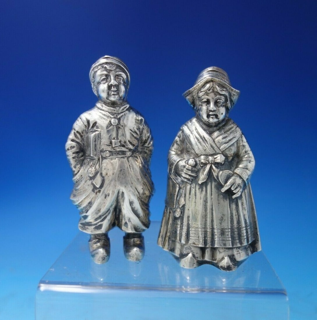 German .800 Silver Dutch Boy Girl Salt Pepper Shaker Set 2pc: German .800 Silver Dutch Boy Girl Salt Pepper Shaker Set 2pc This exquisite German .800 silver salt and pepper shaker set features charming designs of a Dutch boy and girl. Crafted from high-quality s