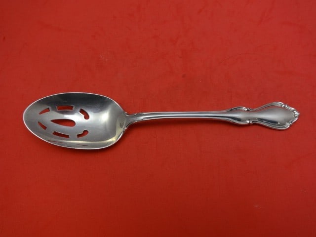 Reed & Barton Hampton Court Sterling Silver Pierced Spoon 8.5": Reed & Barton Hampton Court Sterling Silver Pierced Spoon 8.5" This exquisite serving spoon is crafted by Reed & Barton in the elegant Hampton Court pattern. Made of high-quality sterling silver, this