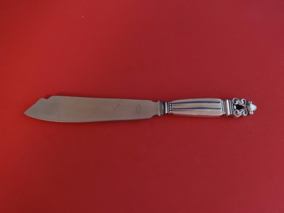Georg Jensen Acorn Sterling Silver Cake Knife 8 3/4 Inch: Georg Jensen Acorn Sterling Silver Cake Knife 8 3/4 Inch This elegant cake knife features a stunning design in the Acorn pattern by Georg Jensen. Crafted from sterling silver with a hollow handle, it