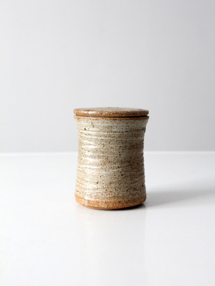 Handmade Vintage Studio Pottery Jar Taupe Glaze 4.625" Height: Handmade Vintage Studio Pottery Jar Taupe Glaze 4.625" Height Discover this charming vintage studio pottery jar, showcasing a unique handmade design. Featuring a slender top lid and a beautiful taupe