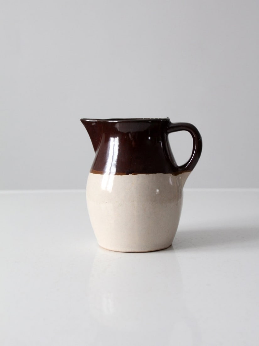Antique Roseville RRP Co Stoneware Pitcher 6.25 inch: Antique Roseville RRP Co Stoneware Pitcher 6.25 inch Discover a charming piece of history with this vintage Roseville Pottery pitcher. Crafted by the renowned Roseville RRP Co, this antique stoneware