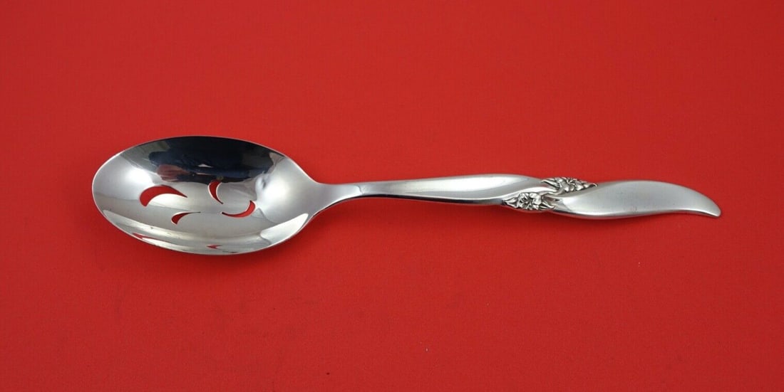 Northumbria Lake Louise Sterling Silver Serving Spoon 8 5/8": Northumbria Lake Louise Sterling Silver Serving Spoon 8 5/8" Elevate your dining experience with this exquisite Lake Louise by Northumbria sterling silver pierced serving spoon. Measuring 8 5/8 inches